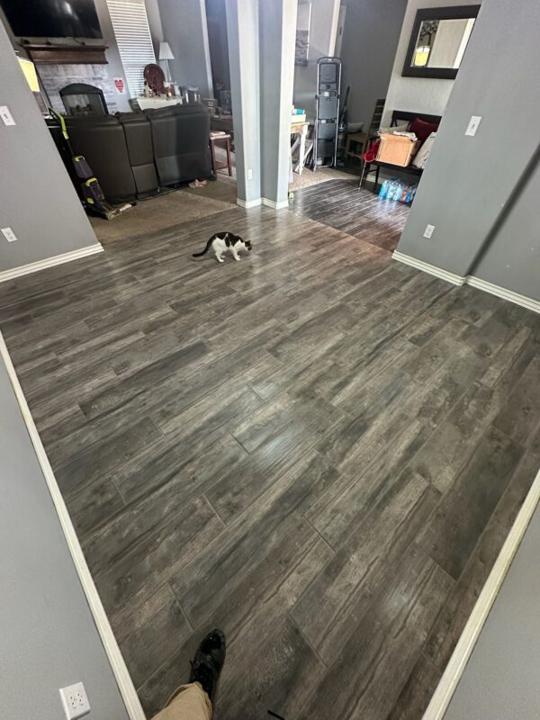 Waterproof luxury vinyl plank installed by Floor Pro in an Oklahoma City home, with the family's dog resting on it